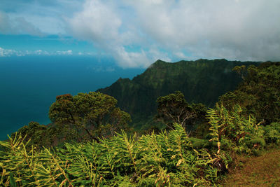 Scenic view of sea and mountains against sky