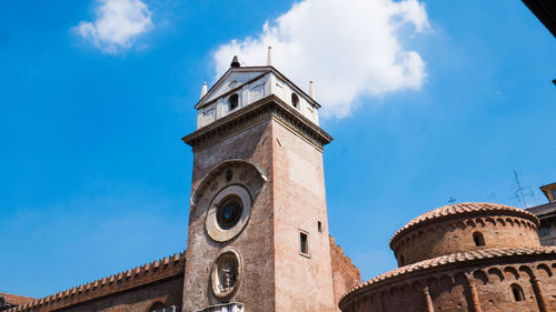 Low angle view of clock tower against cloudy sky