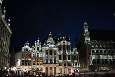 Low angle view of statue in city at night