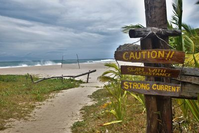 View of wooden signpost on beach