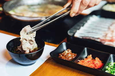 Close-up of person preparing food on table