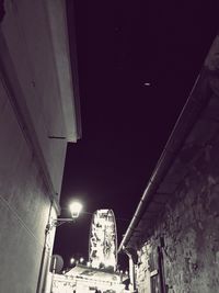 Illuminated tunnel at night