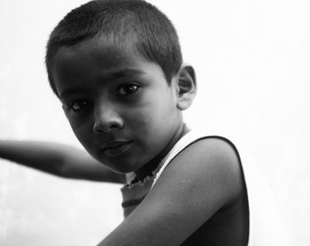 Close-up of boy against white background