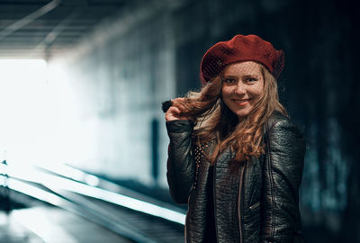 Portrait of smiling young woman standing in winter