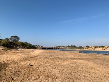 Scenic view of landscape against blue sky