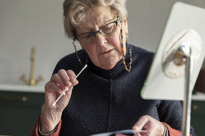 Woman holding cotton swab