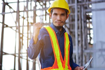 Portrait of smiling man working at construction site