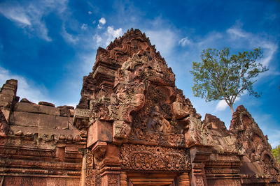 Banteay srei or banteay srey temple site among the ancient ruins of angkor wat hindu temple complex