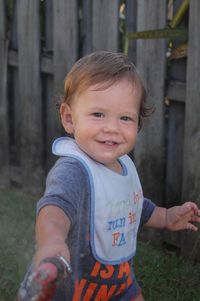 Portrait of smiling baby boy at back yard