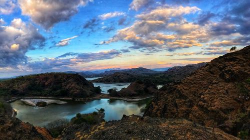 Scenic view of river against sky during sunset