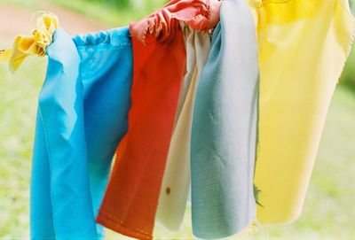 Close-up of clothes drying against blue background