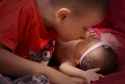 Close-up of boy looking at sister while sitting at home