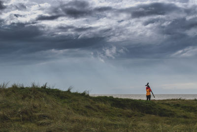 Man standing on beach against sky