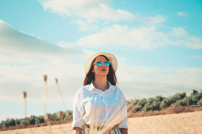 Woman standing on agricultural field