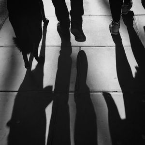 Low section of people standing on tiled floor