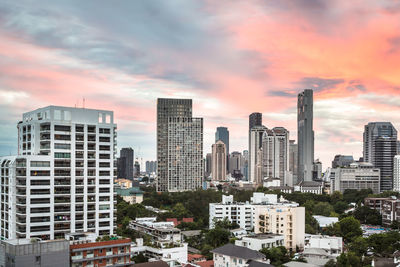 View of cityscape against cloudy sky