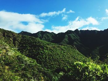 Scenic view of mountains against cloudy sky