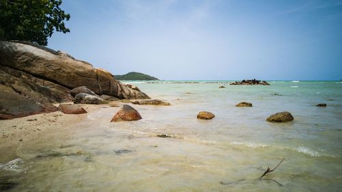 Rocks on beach against sky