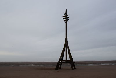 Lifeguard hut on beach against sky