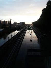Railroad tracks in city against sky