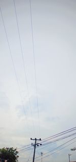 Low angle view of electricity pylon against sky