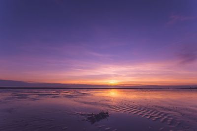 Scenic view of beach against sky during sunset