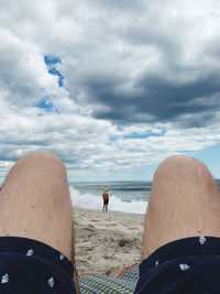 Man on beach against sky