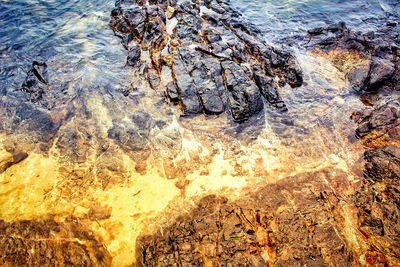 High angle view of rocks by sea