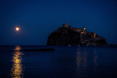 Scenic view of sea against sky at night