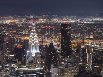 Aerial view of illuminated buildings in city at night