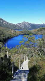 Scenic view of lake against clear blue sky