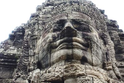 Low angle view of statue against temple