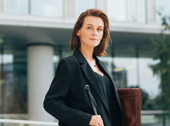 Young businesswoman standing in city