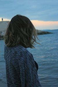 Side view of woman standing at beach