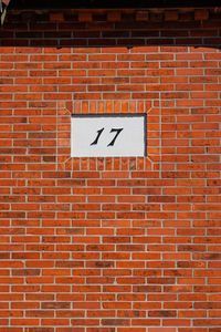 Low angle view of text on brick wall