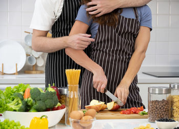 Midsection of woman preparing food at home