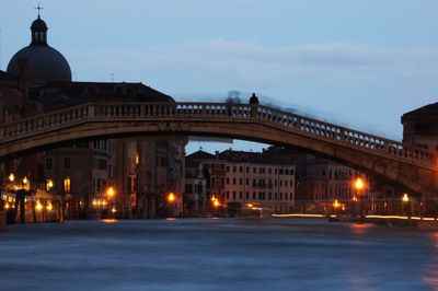 Illuminated city against sky during winter