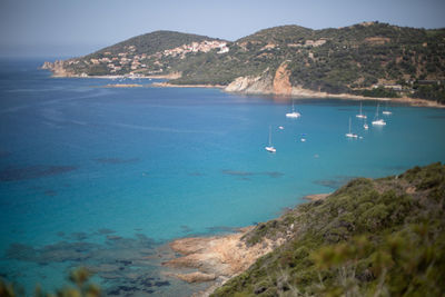Scenic view of sea and mountains against sky