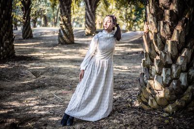 Portrait of woman standing in forest