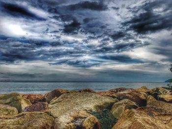 Scenic view of sea against storm clouds