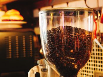 Close-up of coffee beans in glass jar on table