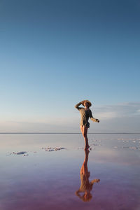 Full length of man on beach against clear sky