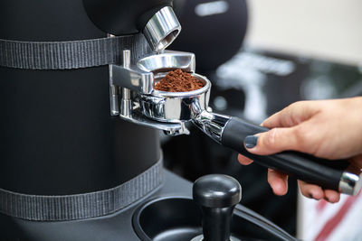 Cropped hand of man holding coffee