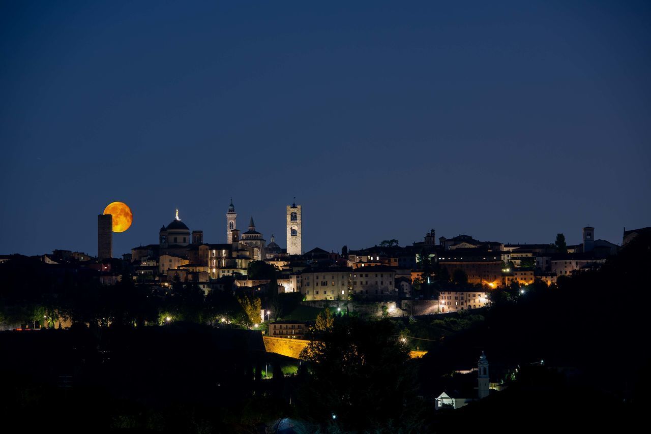 BUILDINGS IN CITY AT NIGHT