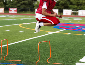 Full length of a man jumping on grassland