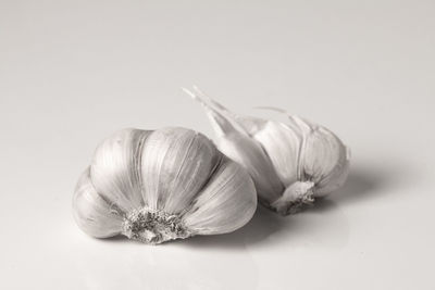 Close-up of garlic on white background