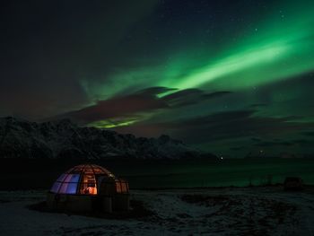 Scenic view of illuminated mountain against sky at night