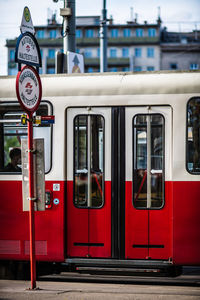 Red train at railroad station in city