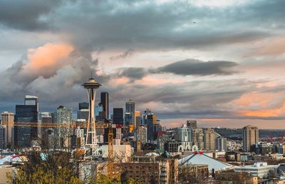 View of cityscape against cloudy sky