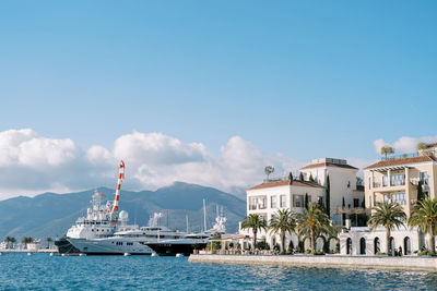 Boats in sea against clear sky